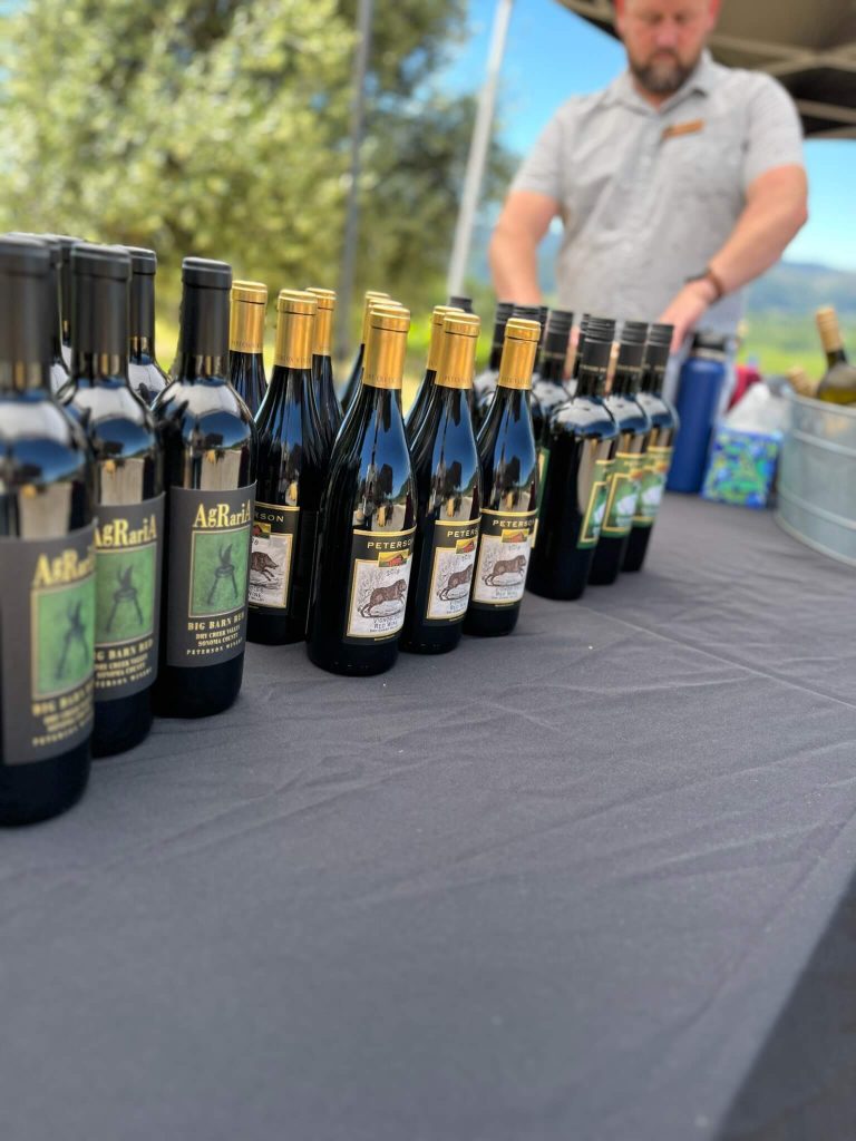 Peterson Winery winemaker showcasing wine bottles