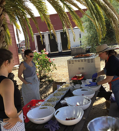 People enjoying wine and food at a Peterson Winery gathering