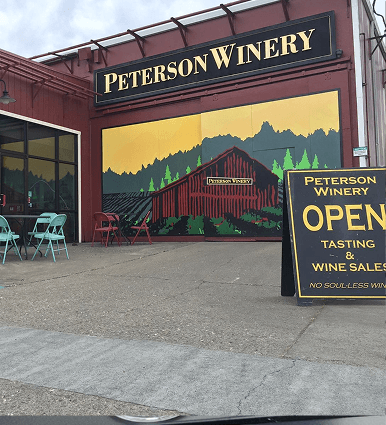 Peterson Winery tasting room and entrance with wine barrels and outdoor seating
